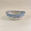 Handbuilt oval ceramic dish with black calligraphic line art on sky blue glaze