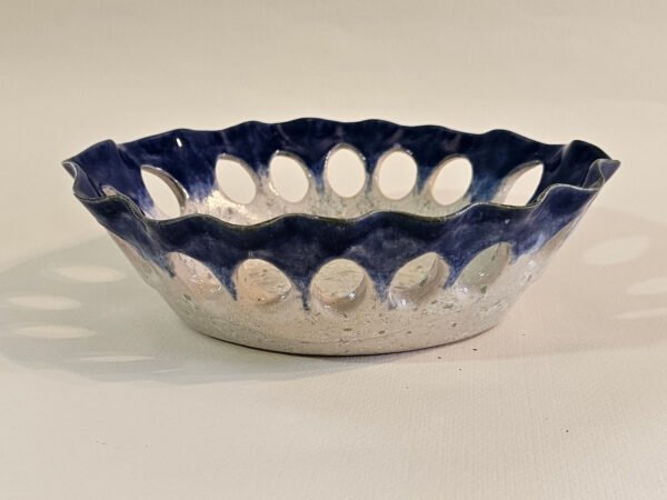 Handbuilt oval ceramic dish with scalloped rim and oval cut-outs in cobalt blue glaze