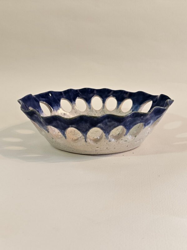 bowl-blue-cutout-3x4 Handbuilt oval ceramic dish with scalloped rim and oval cut-outs in cobalt blue glaze